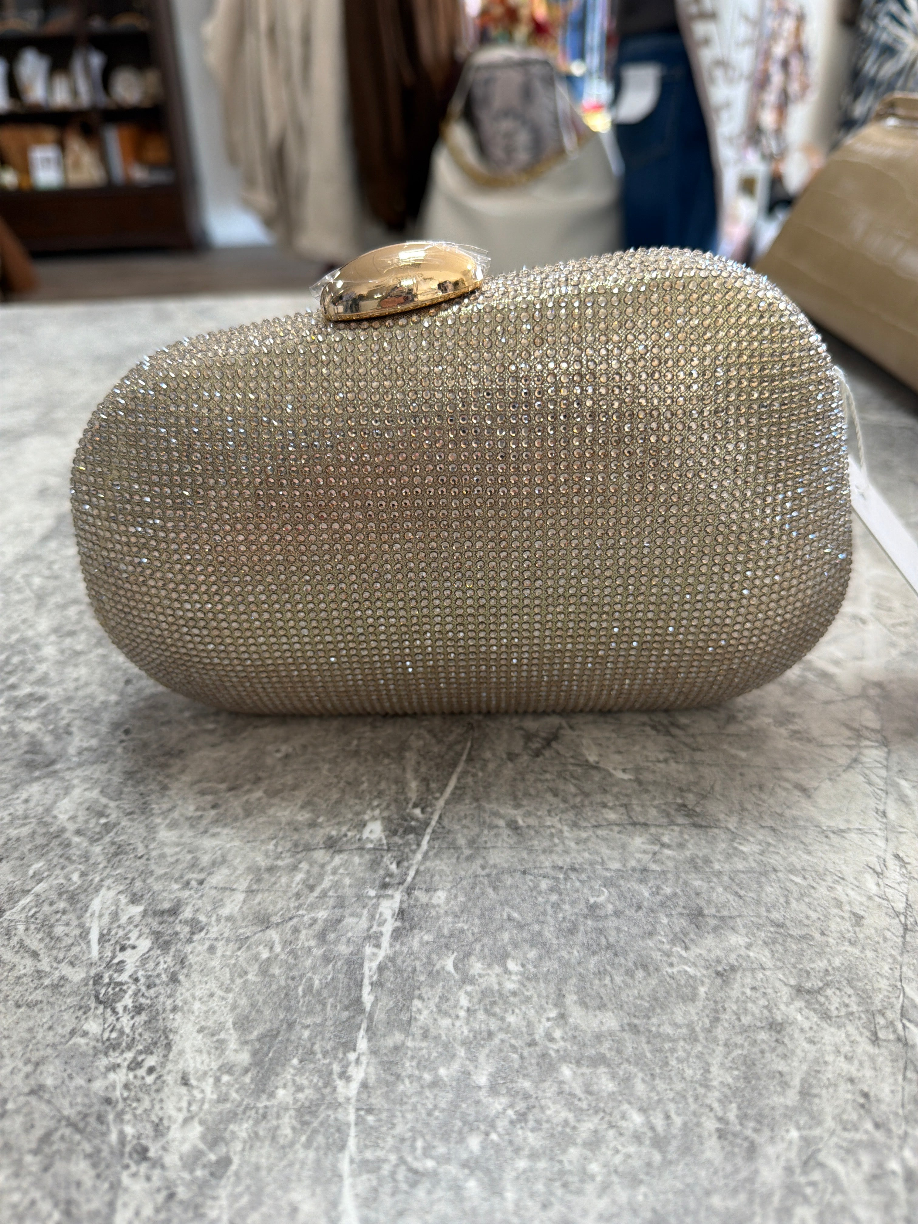 Gold slanted clutch